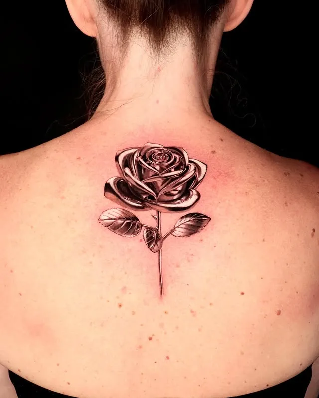 **Delicate Back Bloom Tattoo**