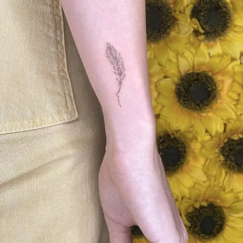 ### Delicate Feather Wrist Tattoo