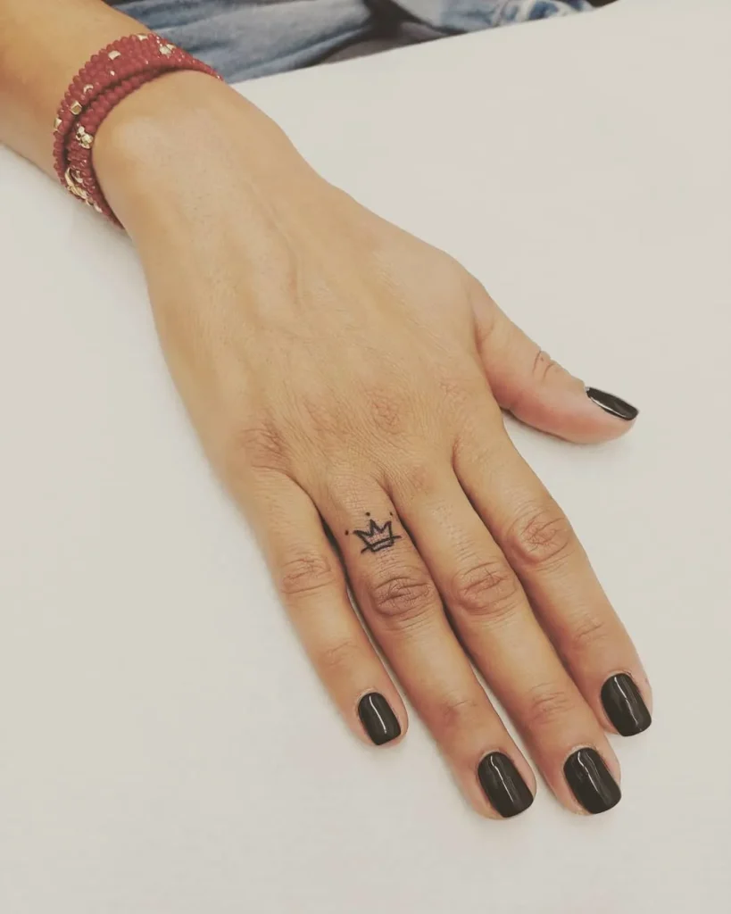 ### Subtle Royalty Finger Tattoo